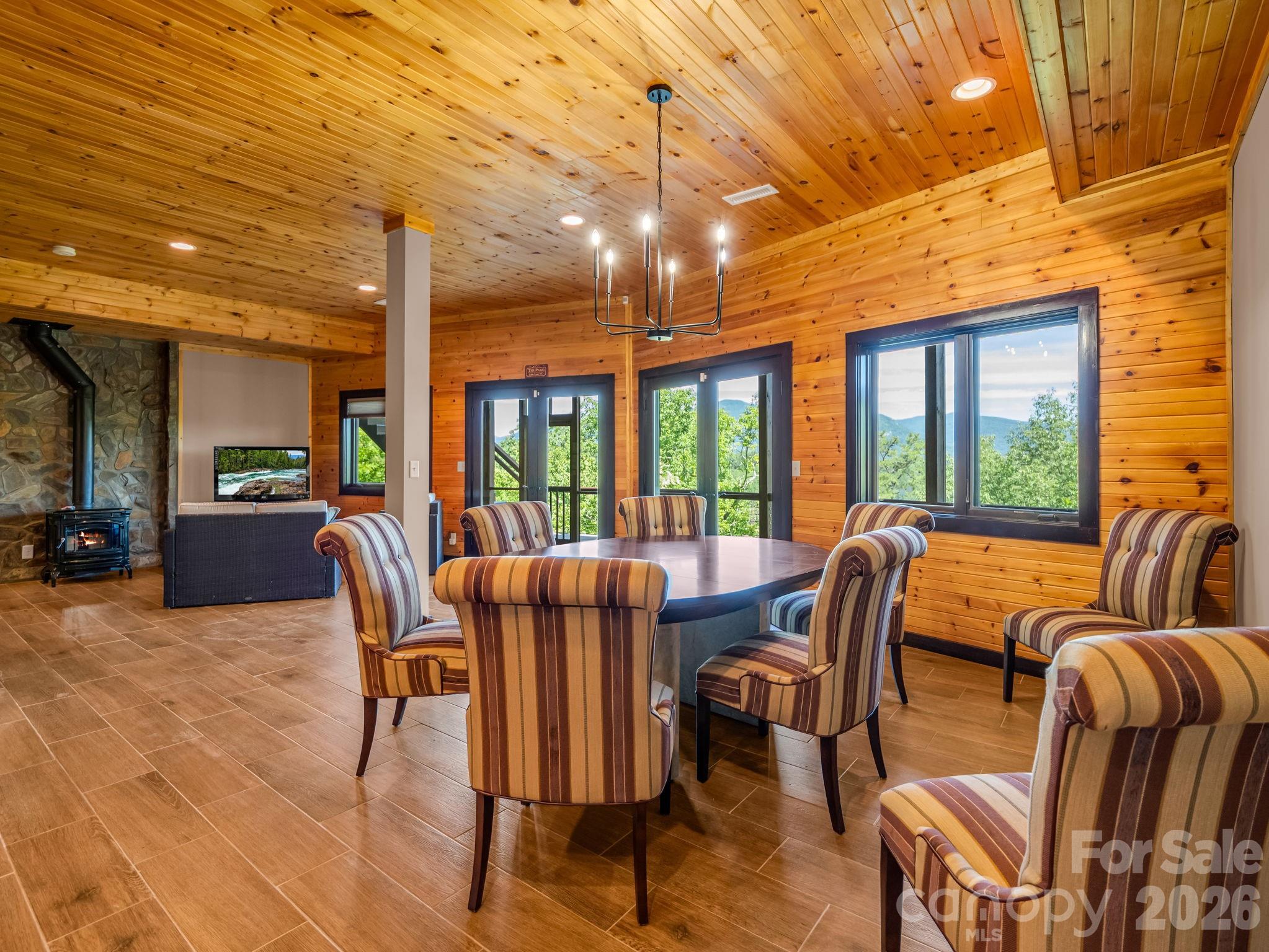 590 Boulder Ridge Lake Lure, NC 28746 - Photo 35 of 48 a view of a dining room with furniture large windows and wooden floor