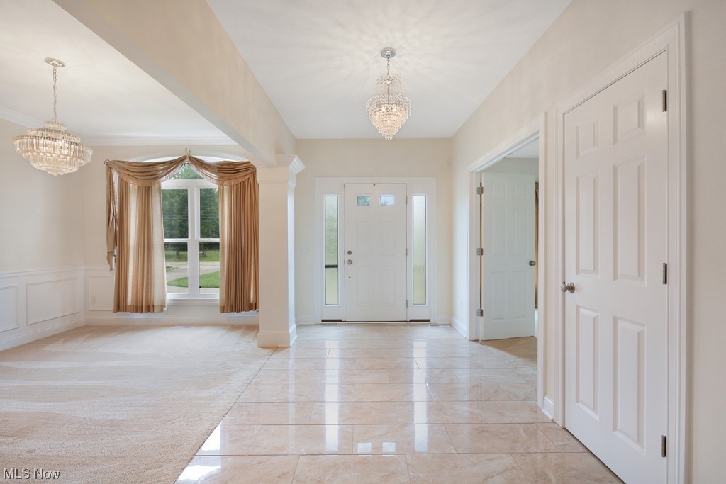 The foyer greets you with a marble floor and is open to the living room, family room and dining room