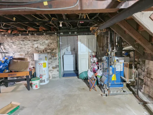 a storage room with water heater and racks