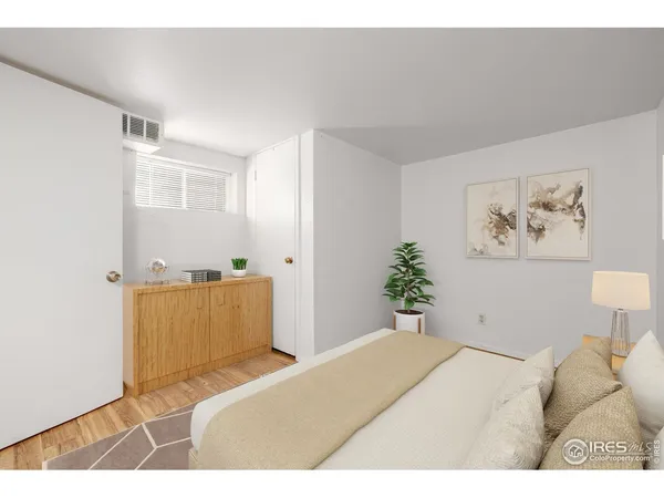 a bedroom with a bed and a painting on the wall