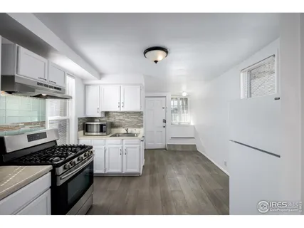 a kitchen with a stove and a refrigerator