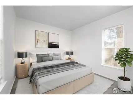 a bedroom with a bed and a potted plant