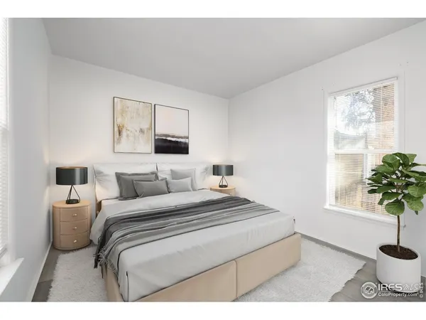 a bedroom with a bed and a potted plant