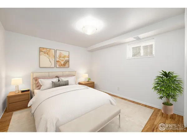 a bedroom with a bed and a potted plant