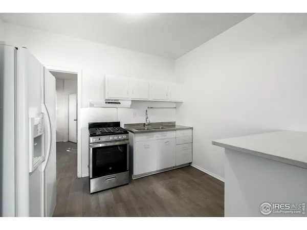 a kitchen with stainless steel appliances a stove a refrigerator and a sink