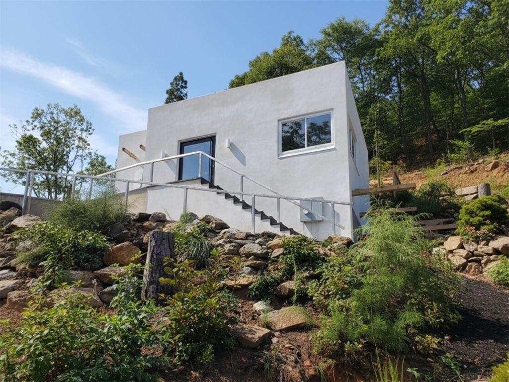 a white house with a yard and plants