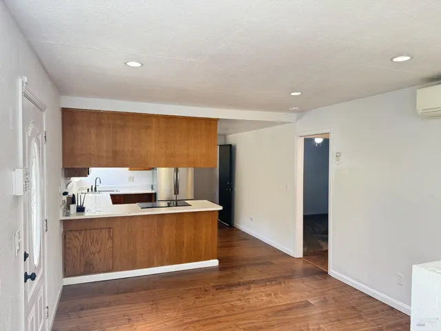 a kitchen with a refrigerator sink and cabinets