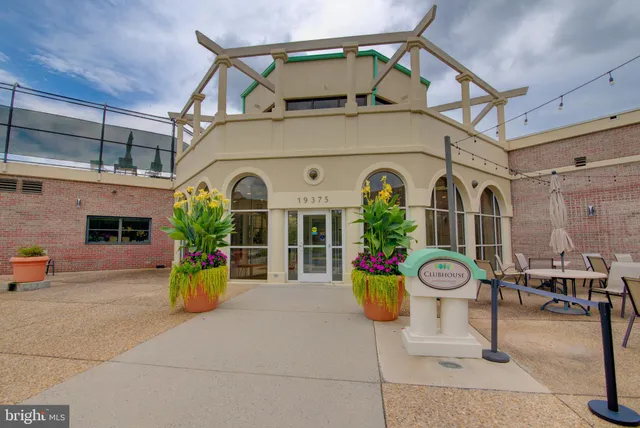 a living room with furniture a table and a potted plant