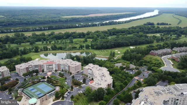 an aerial view of a house with garden space lake view and mountain view in back