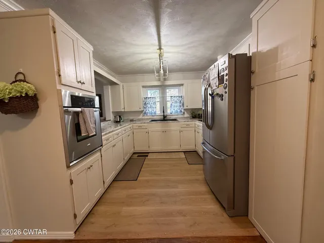 a view of a room with wooden floor