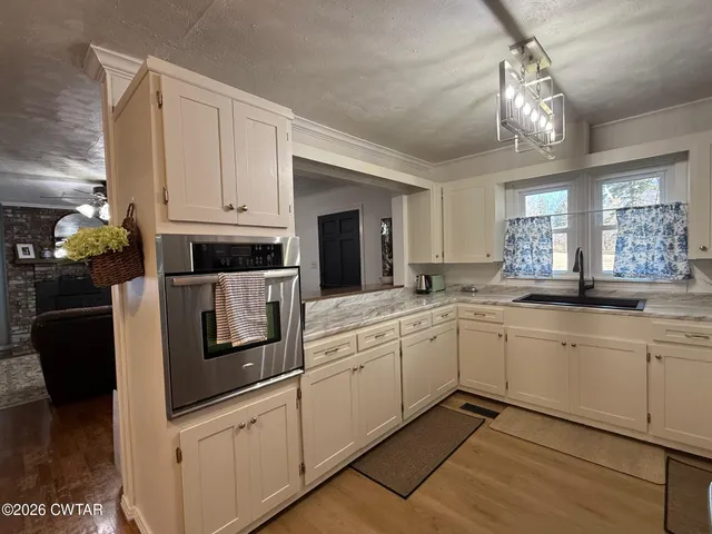 a view of a patio with table and chairs with wooden floor and fence