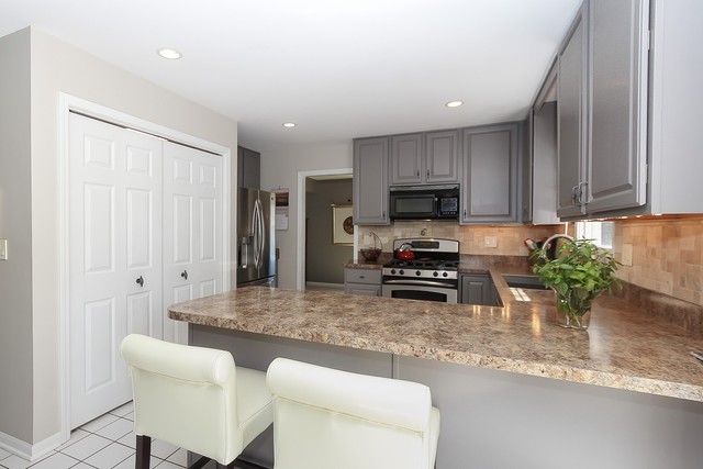 2850 Randall Ridge Drive Elgin, IL 60124 - Photo 7 of 19 a kitchen with granite countertop a refrigerator a stove a sink and a counter space