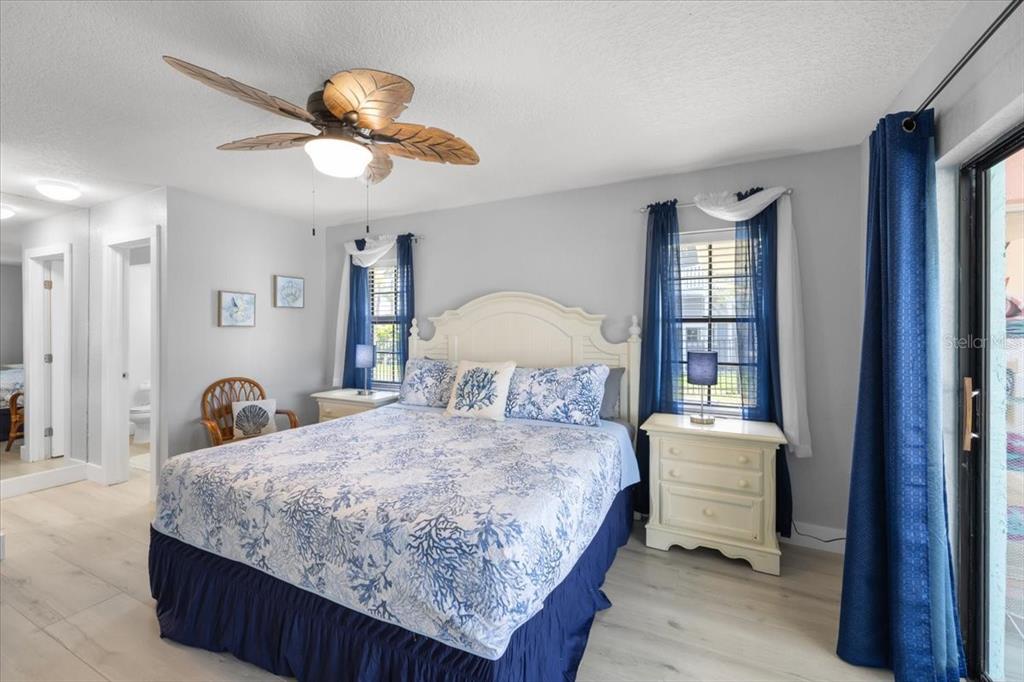 4400 Flexer Drive Hernando Beach, FL 34607 - Photo 11 of 49 a bedroom with a bed and a chandelier