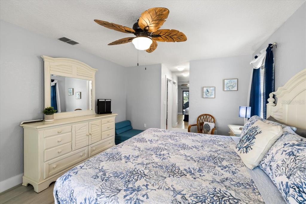 4400 Flexer Drive Hernando Beach, FL 34607 - Photo 12 of 49 a bedroom with a large bed and a chandelier
