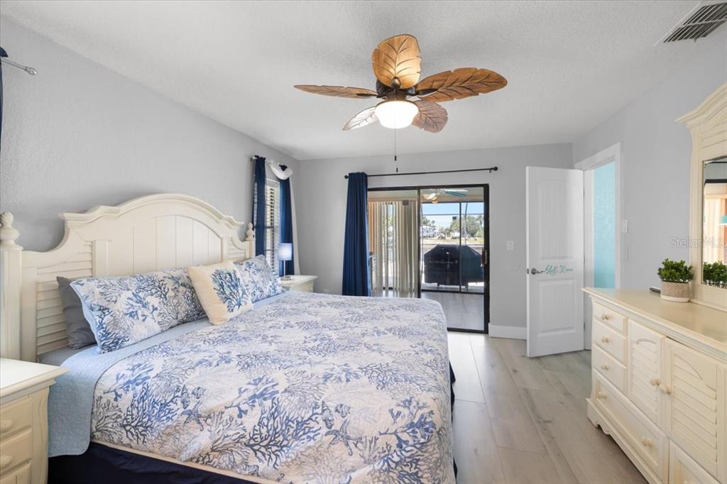 4400 Flexer Drive Hernando Beach, FL 34607 - Photo 13 of 49 a bed room with a bed and a chandelier