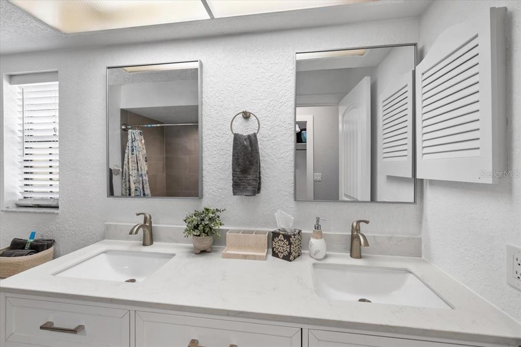 4400 Flexer Drive Hernando Beach, FL 34607 - Photo 14 of 49 a bathroom with double vanity sinks and a mirror