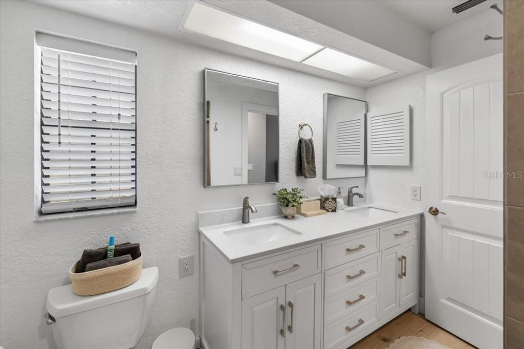 4400 Flexer Drive Hernando Beach, FL 34607 - Photo 15 of 49 a bathroom with a toilet a sink a mirror a bathtub and vanity