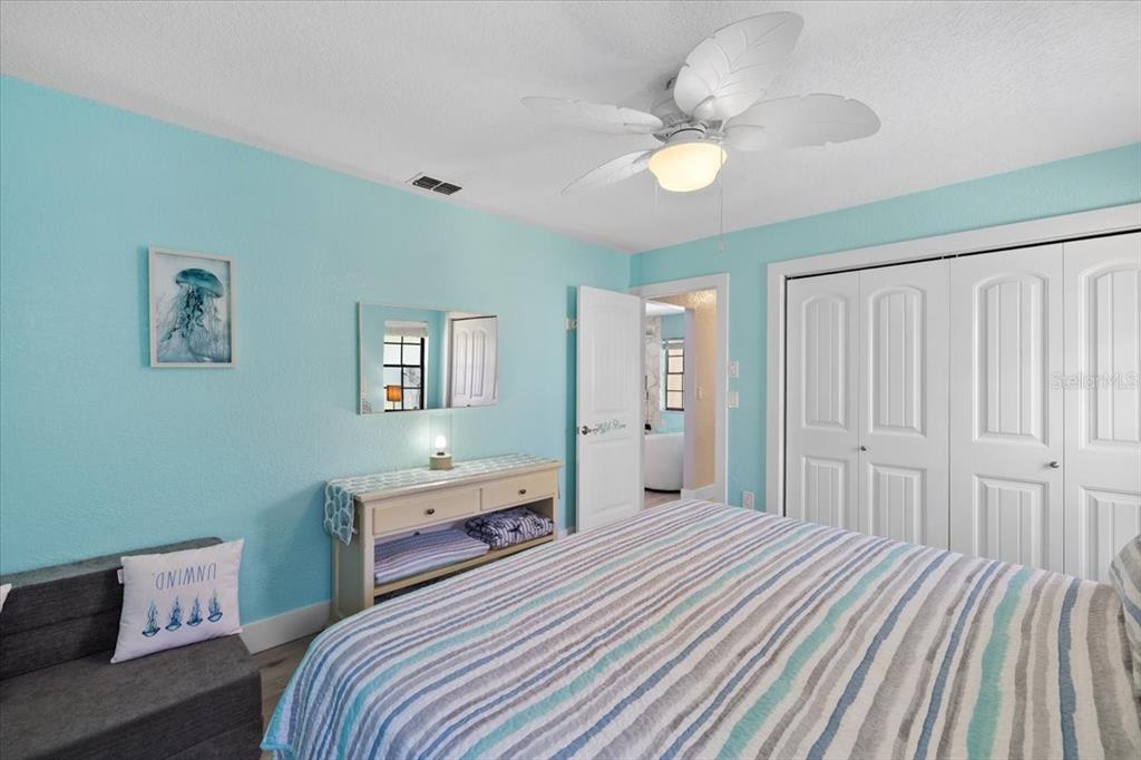 4400 Flexer Drive Hernando Beach, FL 34607 - Photo 23 of 49 a bedroom with a bed and a chandelier
