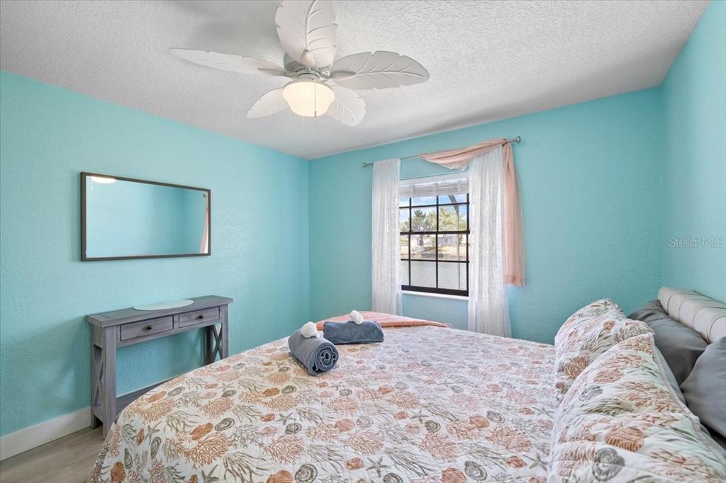 4400 Flexer Drive Hernando Beach, FL 34607 - Photo 26 of 49 a bedroom with a bed and a chandelier