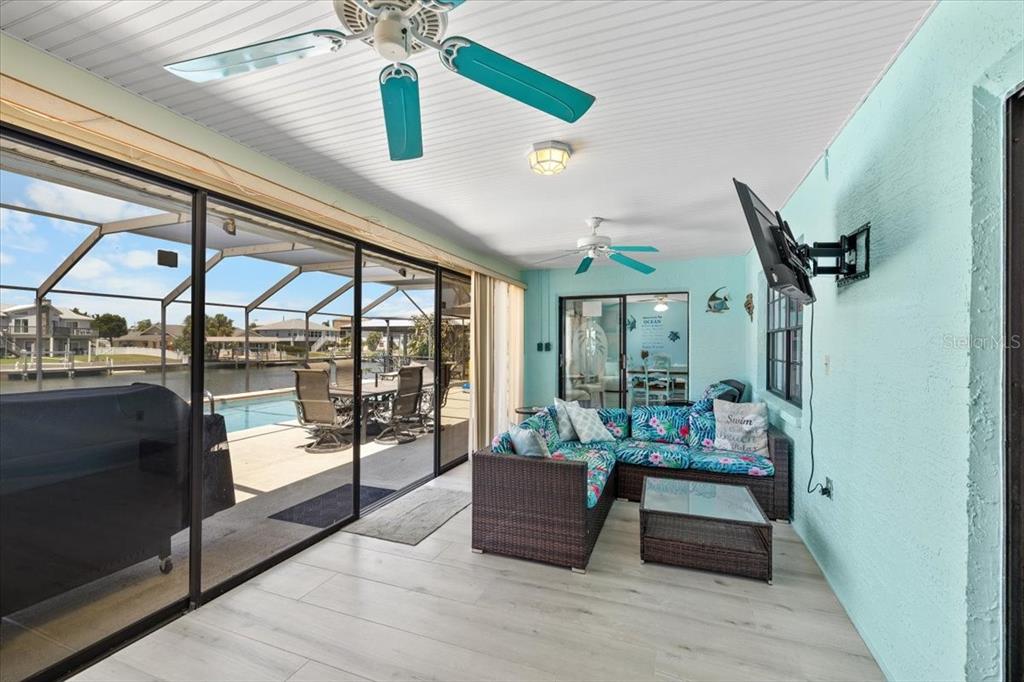 4400 Flexer Drive Hernando Beach, FL 34607 - Photo 27 of 49 a room with lots of wooden furniture and large windows