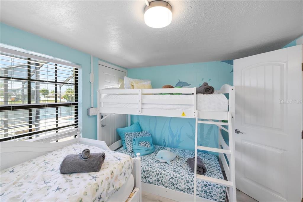 4400 Flexer Drive Hernando Beach, FL 34607 - Photo 32 of 49 a room with a bed and a chandelier