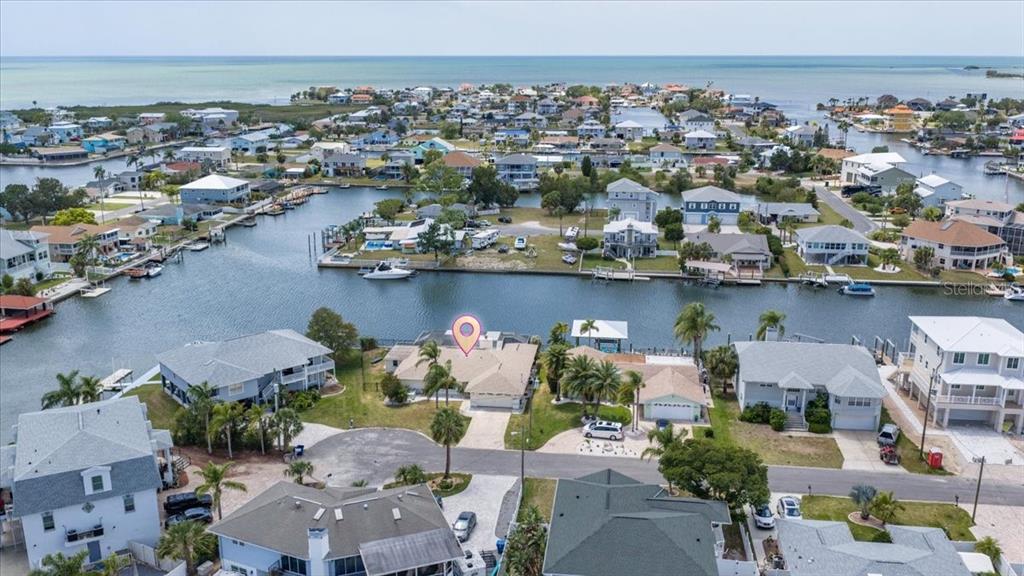 4400 Flexer Drive Hernando Beach, FL 34607 - Photo 43 of 49 an aerial view of a city with lots of residential buildings and ocean view in back