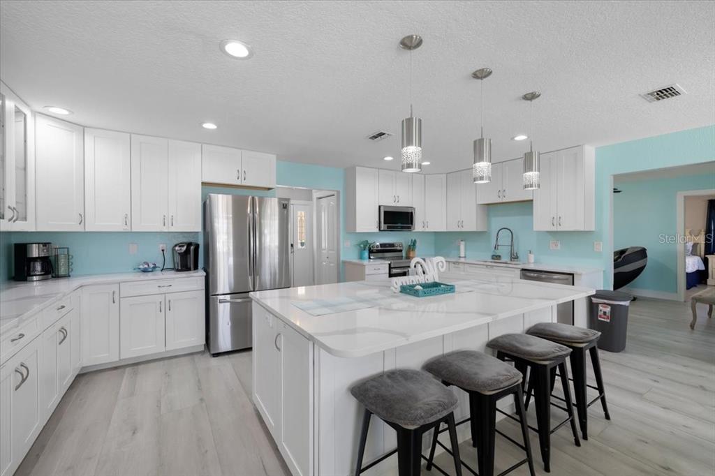 4400 Flexer Drive Hernando Beach, FL 34607 - Photo 7 of 49 a kitchen with refrigerator and cabinets