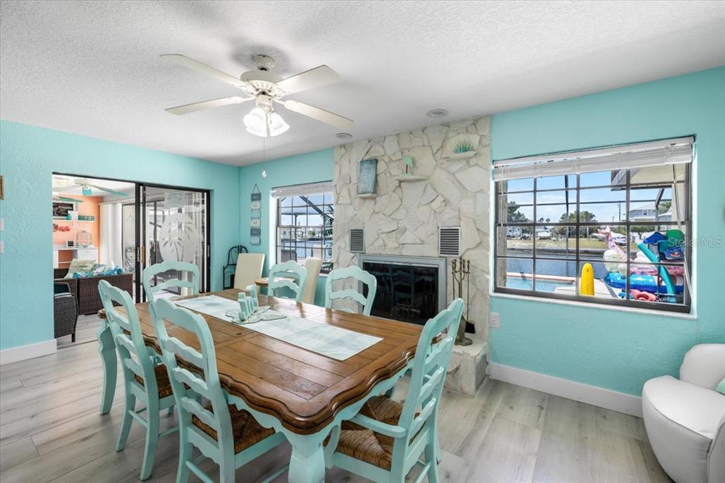 4400 Flexer Drive Hernando Beach, FL 34607 - Photo 8 of 49 a view of a dining room with furniture a chandelier and wooden floor