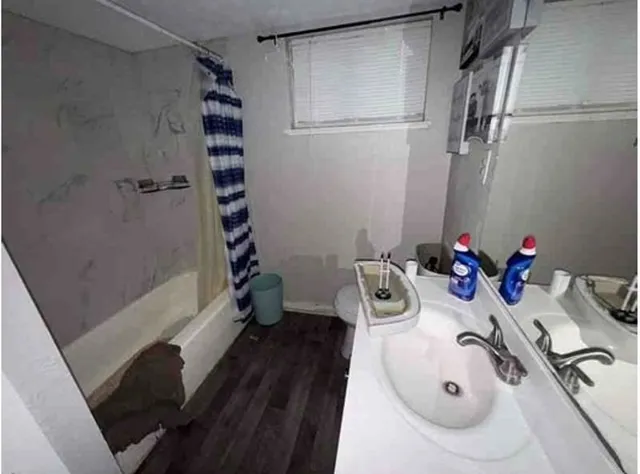 a bathroom with a tub sink and mirror