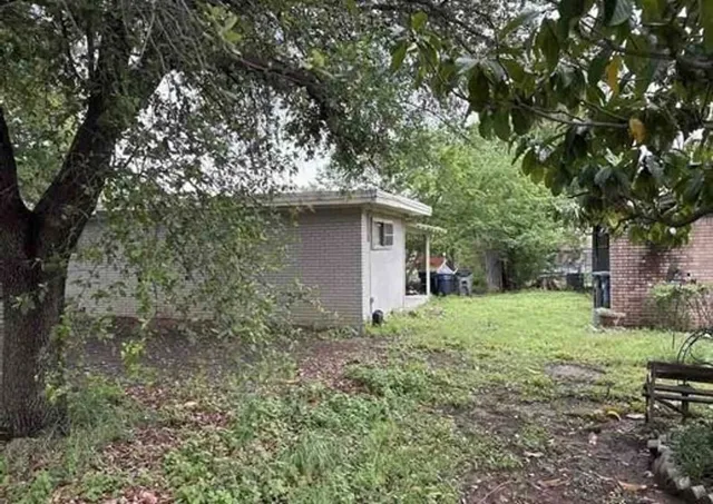 a yellow house in middle of the forest