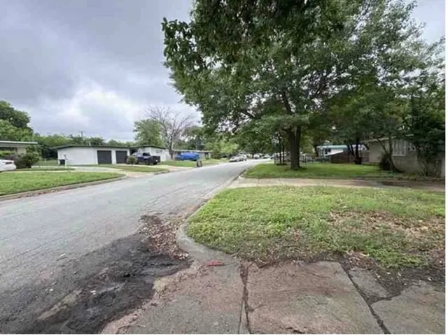 a big yard with lots of green space and trees