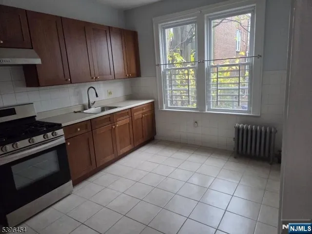 a kitchen with a sink stove and cabinets