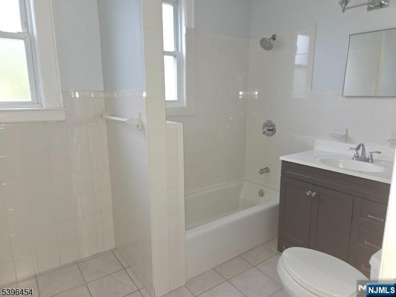 292 Leslie Street, Unit 292 Newark, NJ 07112 - Photo 8 of 9 a bathroom with a sink a toilet and bathtub