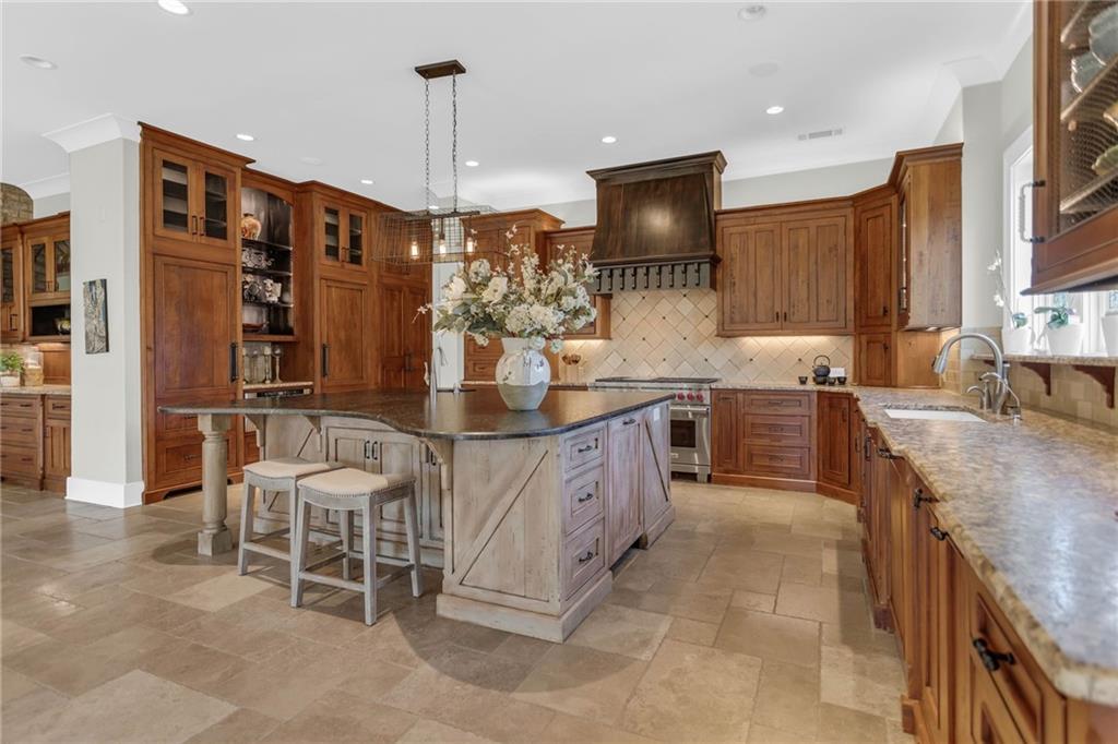 1086 Arbor Hill Road Canton, GA 30115 - Photo 17 of 98 a large kitchen with granite countertop a sink counter space cabinets and stainless steel appliances