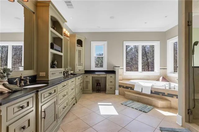 a bathroom with a granite countertop sink a large mirror and a shower