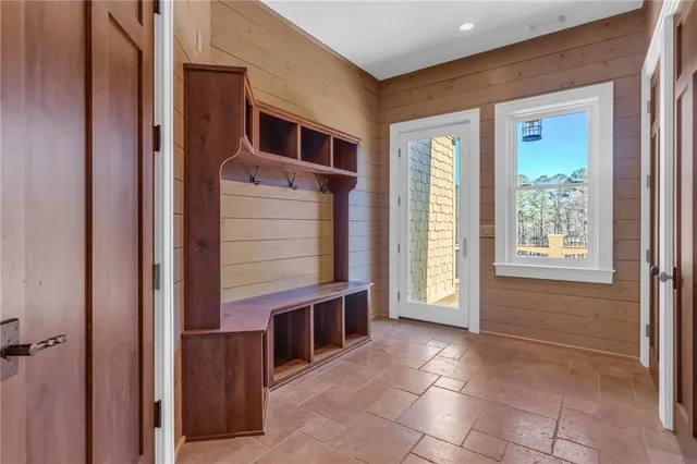 a bathroom with a granite countertop sink a toilet a mirror and shower