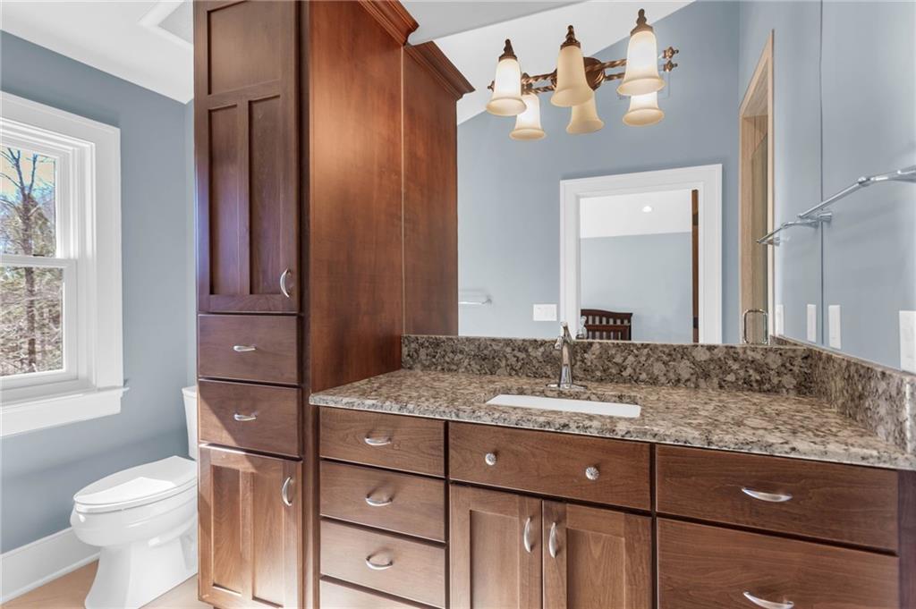 1086 Arbor Hill Road Canton, GA 30115 - Photo 36 of 98 a bathroom with a granite countertop sink toilet and mirror