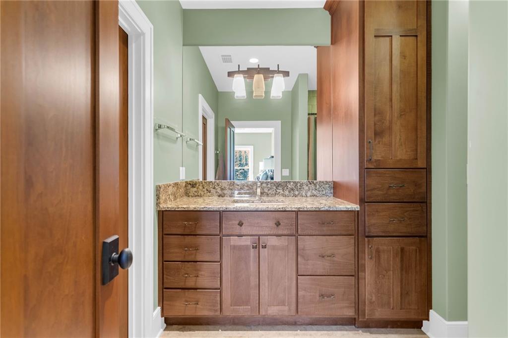 1086 Arbor Hill Road Canton, GA 30115 - Photo 41 of 98 a bathroom with a granite countertop sink and a mirror