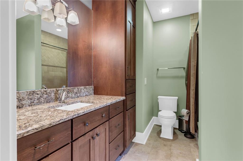 1086 Arbor Hill Road Canton, GA 30115 - Photo 42 of 98 a bathroom with a granite countertop sink a toilet and a mirror