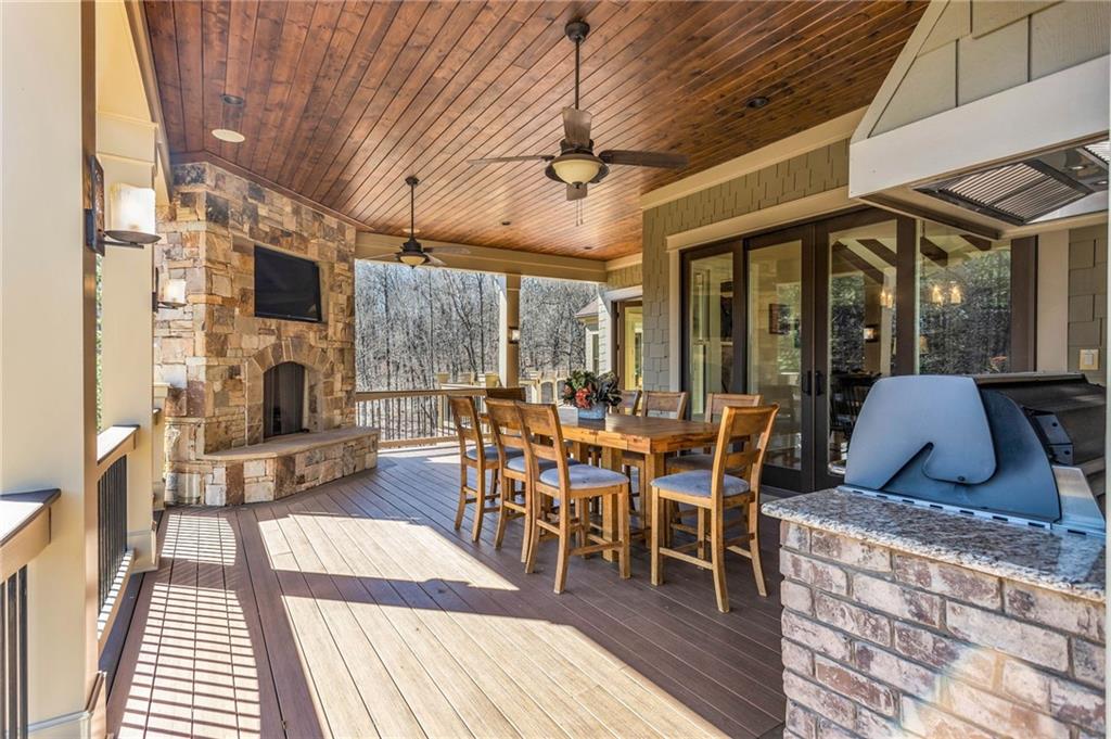 1086 Arbor Hill Road Canton, GA 30115 - Photo 48 of 98 a dining room with wooden floor a table and chairs