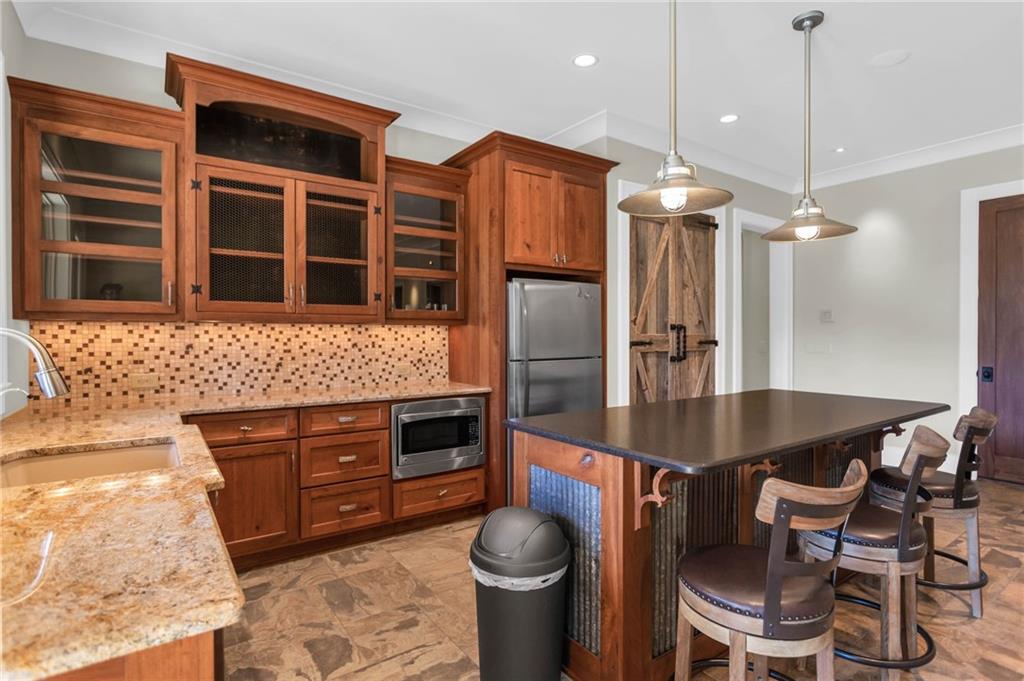 1086 Arbor Hill Road Canton, GA 30115 - Photo 61 of 98 a kitchen with stainless steel appliances granite countertop a stove a sink and a refrigerator