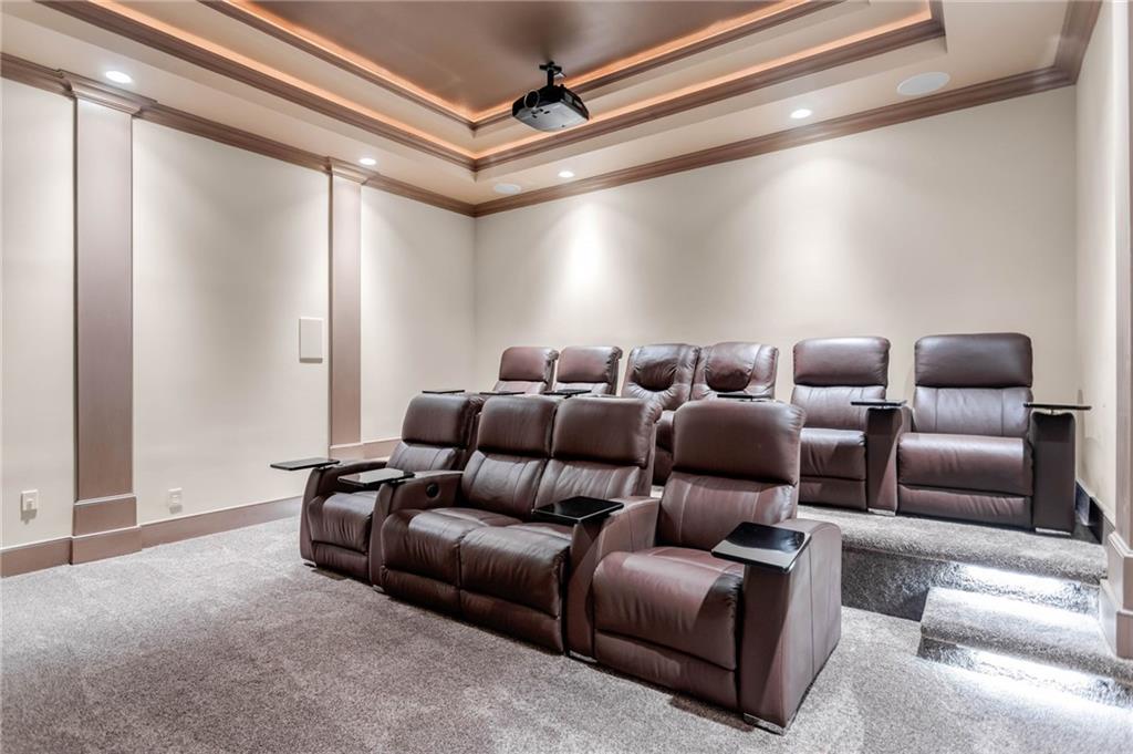 1086 Arbor Hill Road Canton, GA 30115 - Photo 65 of 98 a media room with lots of chairs and a projector screen