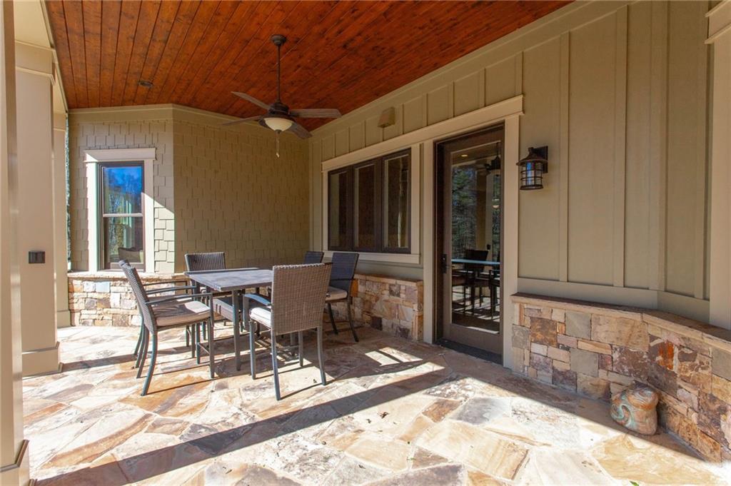1086 Arbor Hill Road Canton, GA 30115 - Photo 70 of 98 a view of a patio with table and chairs and wooden floor