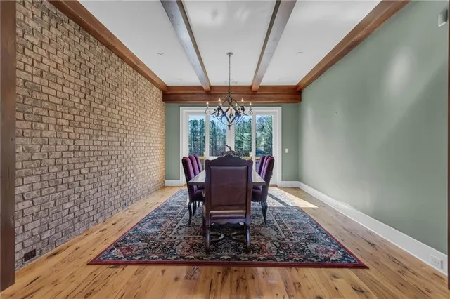 a view of a hallway with wooden floor and a living room