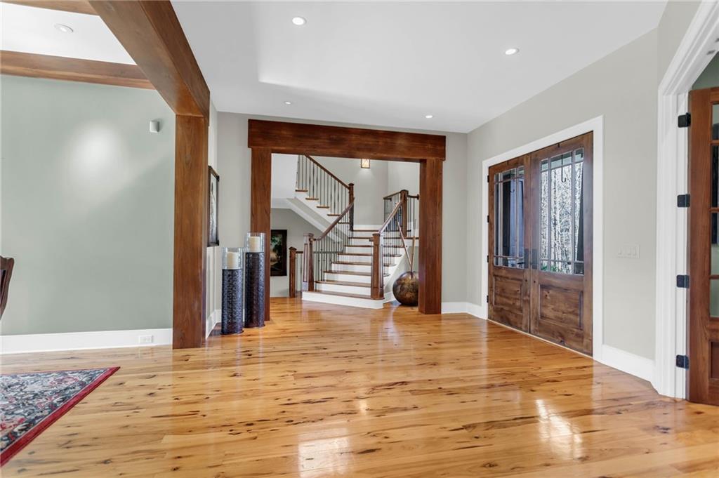 1086 Arbor Hill Road Canton, GA 30115 - Photo 10 of 98 a view of a hallway with wooden floor and a living room