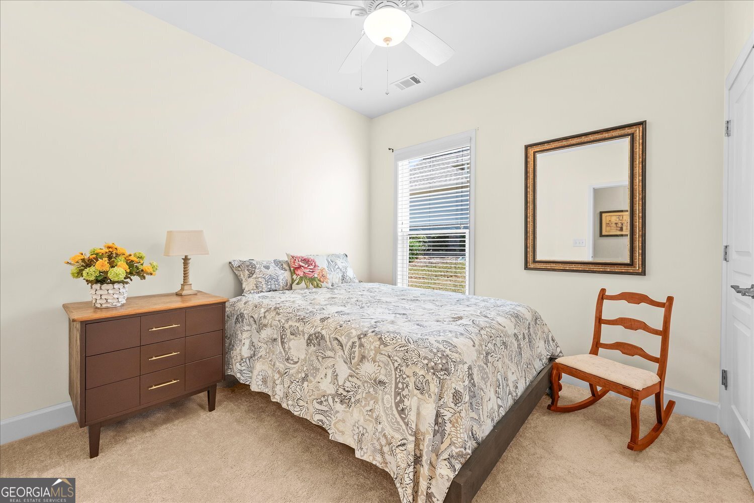 1071 Southern Pne Road Greensboro, GA 30642 - Photo 10 of 35 a bedroom with a bed and a chandelier