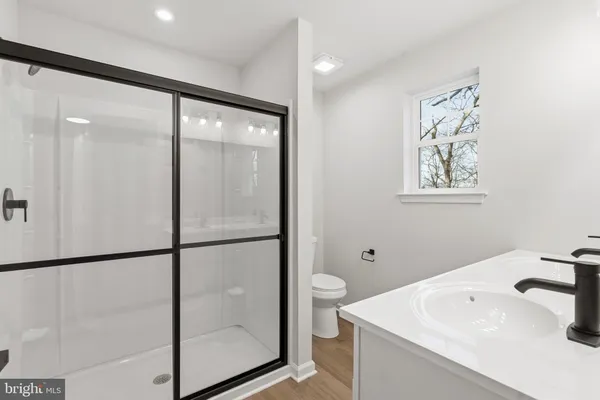 a bathroom with a glass shower door