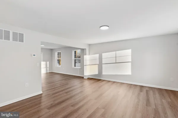 a view of wooden floor and windows in a room
