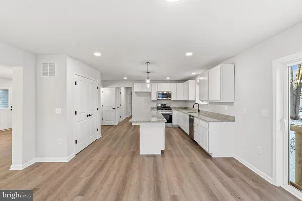a kitchen with a refrigerator and a sink