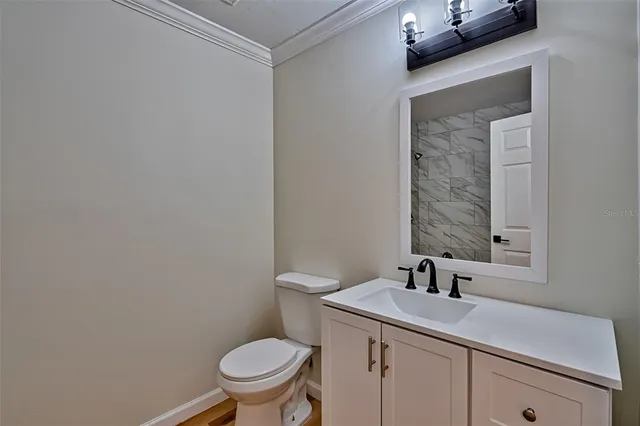 a bathroom with a sink a toilet and mirror